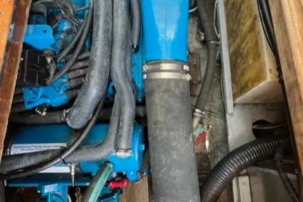 Slide: The Image of Engine compartment of a 1989 Cape Dory Flybridge Cruiser with blue components. - 22