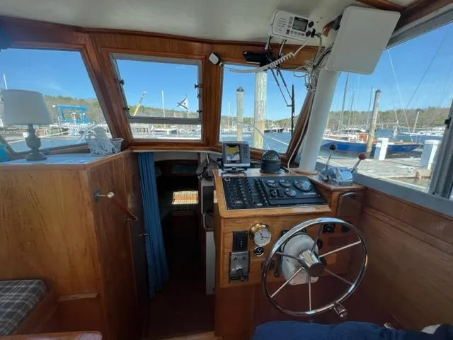 Slide: The Image of Interior view of a 1989 Cape Dory Flybridge Cruiser cockpit at the marina. - 4