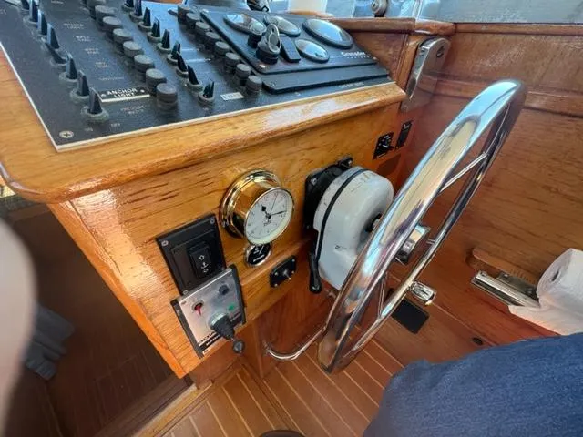 Slide: The Image of 1989 Cape Dory Flybridge Cruiser helm with wooden dashboard. - 5