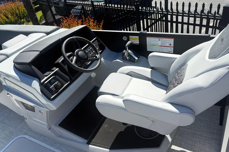 Slide: The Image of Captain's seat and helm of 2026 Alera 23Q boat, featuring modern controls and steering wheel. - 10