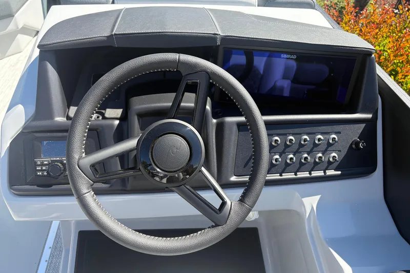 Slide: The Image of Steering wheel and dashboard of 2026 Alera 23Q boat with control panel and display. - 11
