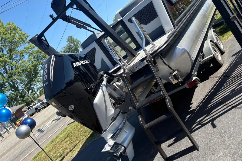 Slide: The Image of 2026 Alera 23Q boat with Mercury 300 V8 engine on trailer, parked outdoors. - 16