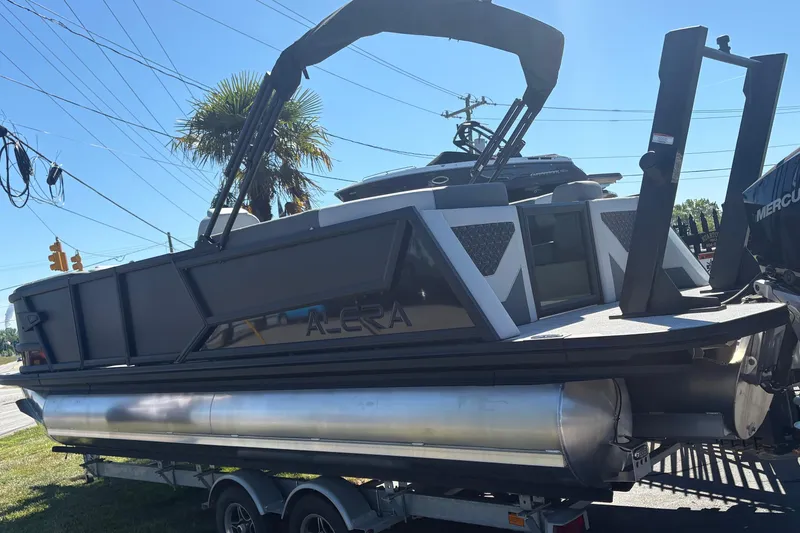 Slide: The Image of 2026 Alera 23Q pontoon boat on trailer, featuring sleek design and modern amenities. - 2