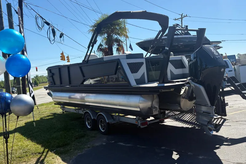 Slide: The Image of 2026 Alera 23Q pontoon boat on trailer, displayed outdoors with balloons. - 3