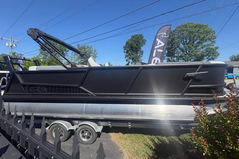Slide: The Image of 2026 Alera 23Q pontoon boat on trailer, displayed outdoors under clear blue sky. - 4