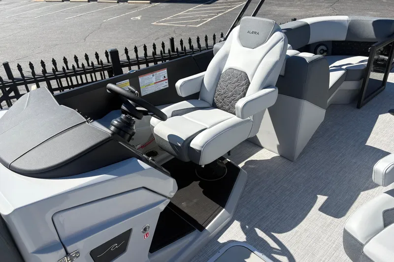 Slide: The Image of Captain's seat of 2026 Alera 23Q boat, featuring modern design and comfortable upholstery. - 9
