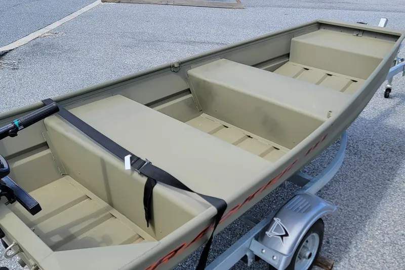 Slide: The Image of 2025 Tracker Grizzly 10 Jon boat on trailer, featuring spacious interior and durable design. - 5