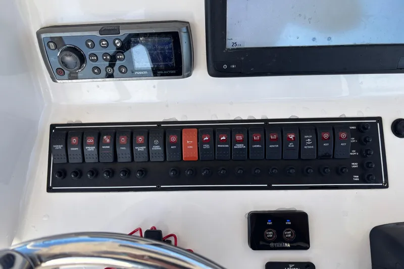 Slide: The Image of Control panel of a 2015 Pursuit S 280 Sport boat with switches and display. - 10