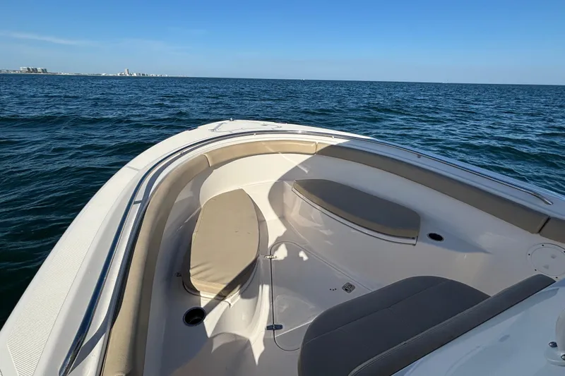 Slide: The Image of 2015 Pursuit S 280 Sport boat on open water, featuring spacious seating area. - 12