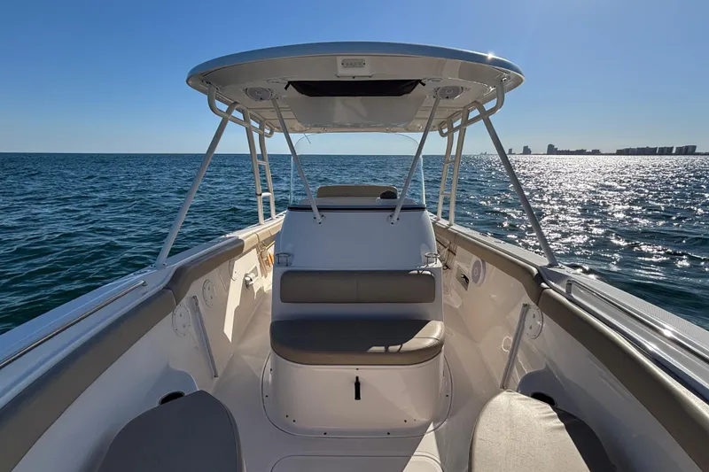 Slide: The Image of 2015 Pursuit S 280 Sport boat on open water, sunny day, clear sky. - 15