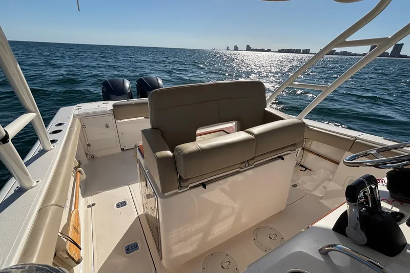 Slide: The Image of 2015 Pursuit S 280 Sport boat interior with ocean view and dual engines. - 17