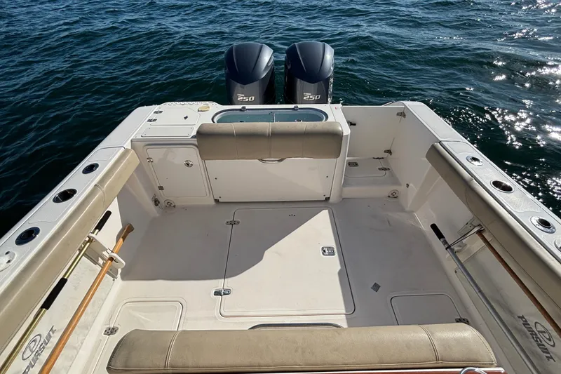 Slide: The Image of 2015 Pursuit S 280 Sport boat deck with twin engines on open water. - 18