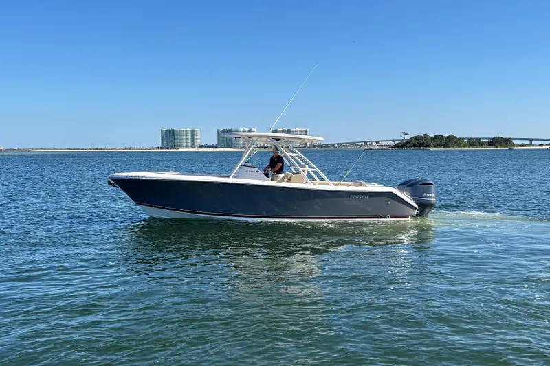 Slide: The Image of 2015 Pursuit S 280 Sport boat cruising on calm water under clear blue sky. - 2