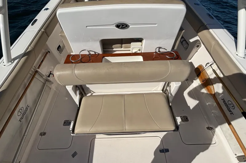 Slide: The Image of 2015 Pursuit S 280 Sport boat interior with beige seating and cup holders. - 26