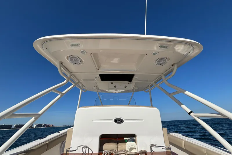 Slide: The Image of 2015 Pursuit S 280 Sport boat on open water, clear blue sky. - 27