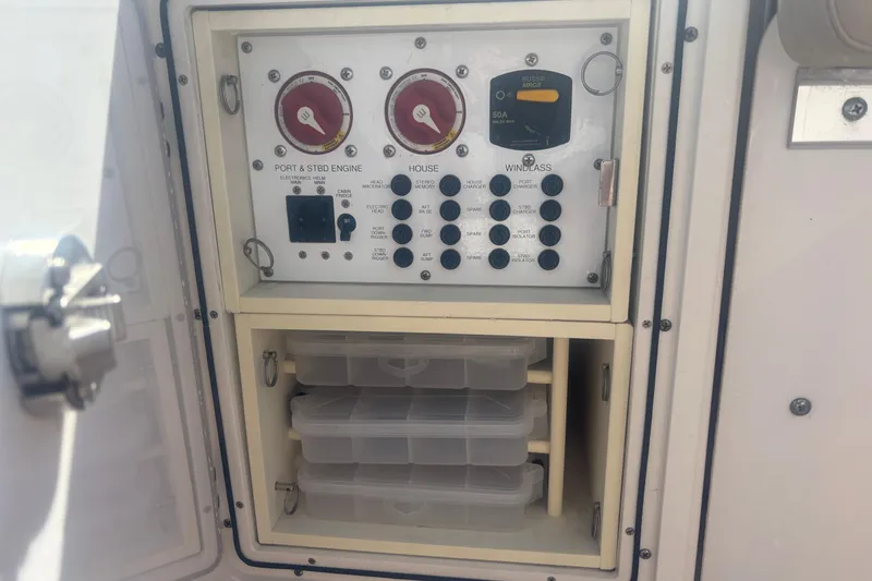 Slide: The Image of Electrical panel and storage on a 2015 Pursuit S 280 Sport boat. - 28