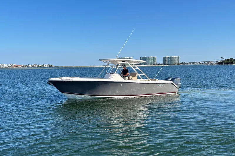 Slide: The Image of 2015 Pursuit S 280 Sport boat cruising on calm waters under clear blue sky. - 3