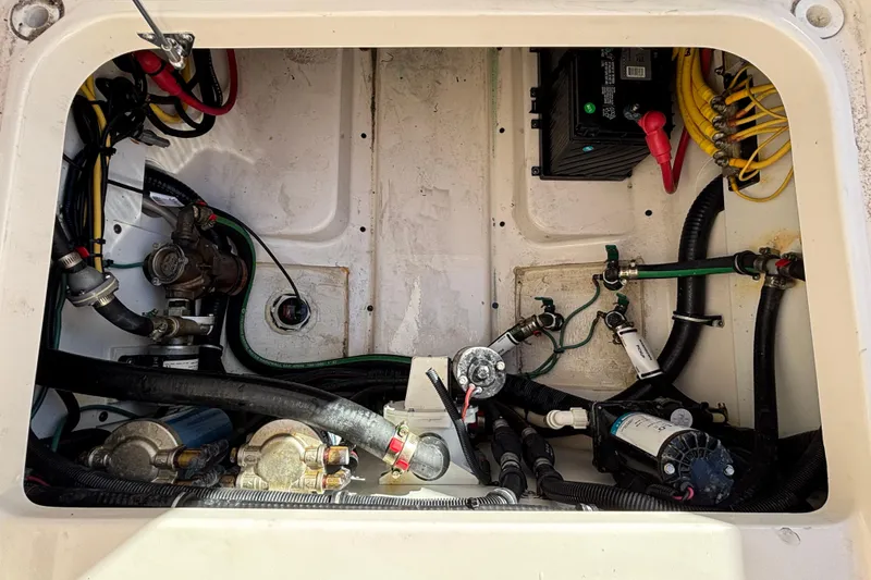 Slide: The Image of 2015 Pursuit S 280 Sport engine compartment with wiring and mechanical components. - 30