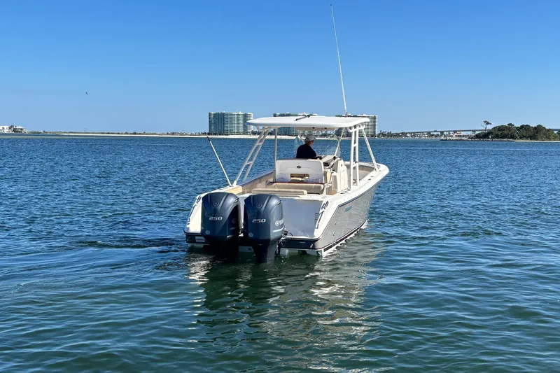 Slide: The Image of 2015 Pursuit S 280 Sport boat cruising on calm waters under clear blue sky. - 5