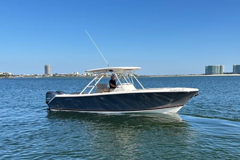 Slide: The Image of 2015 Pursuit S 280 Sport boat cruising on calm waters under clear blue sky. - 6