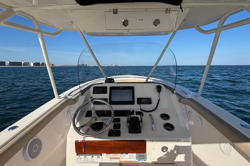 Slide: The Image of 2015 Pursuit S 280 Sport boat dashboard with ocean view and clear blue sky. - 7