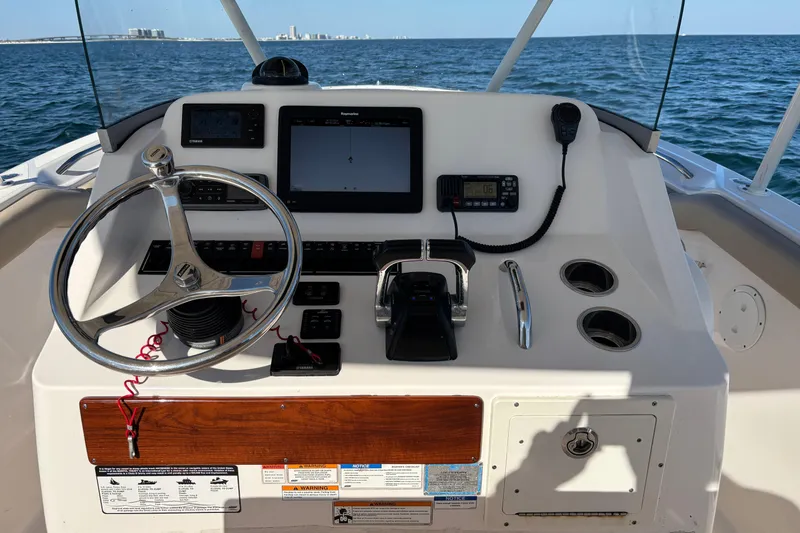 Slide: The Image of Helm of 2015 Pursuit S 280 Sport boat with steering wheel and navigation equipment. - 8