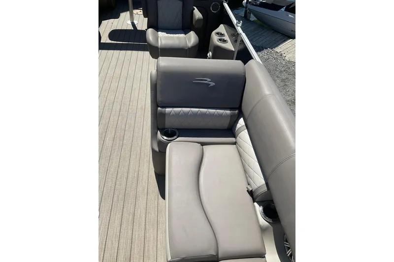 Slide: The Image of 2019 Bennington SX 20 SSRX boat interior with gray cushioned seating and cup holders. - 11