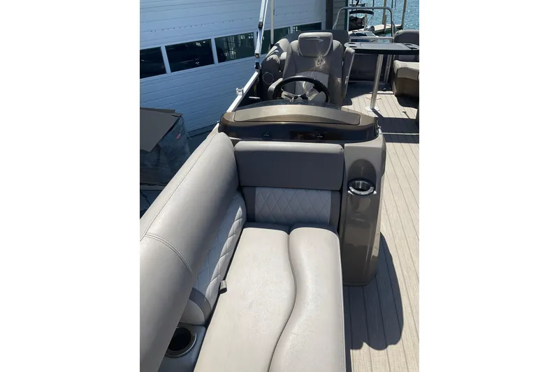 Slide: The Image of 2019 Bennington SX 20 SSRX pontoon boat interior with plush seating and steering console. - 12