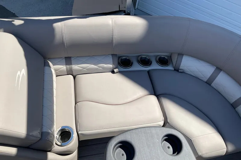 Slide: The Image of 2019 Bennington SX 20 SSRX boat interior with gray cushioned seating and multiple cup holders. - 17