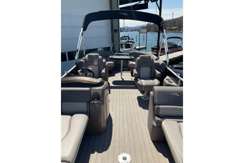 Slide: The Image of 2019 Bennington SX 20 SSRX pontoon boat with spacious seating and lake view. - 19