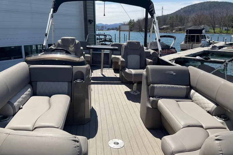 Slide: The Image of 2019 Bennington SX 20 SSRX pontoon boat with luxurious seating and scenic lake view. - 20