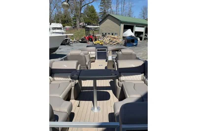 Slide: The Image of 2019 Bennington SX 20 SSRX pontoon boat interior with beige seating and central table. - 22