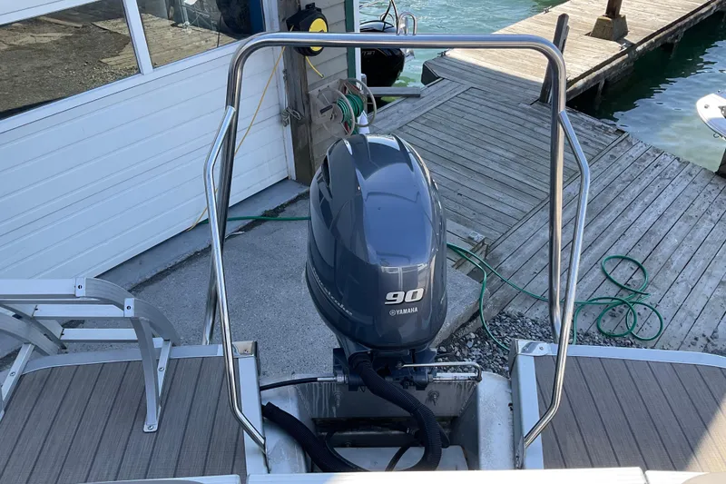 Slide: The Image of 2019 Bennington SX 20 SSRX with Yamaha 90 outboard motor at dockside. - 25