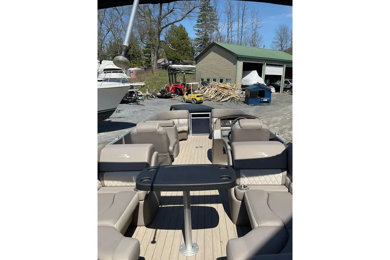 Slide: The Image of 2019 Bennington SX 20 SSRX pontoon boat with beige seating and outdoor setting. - 26