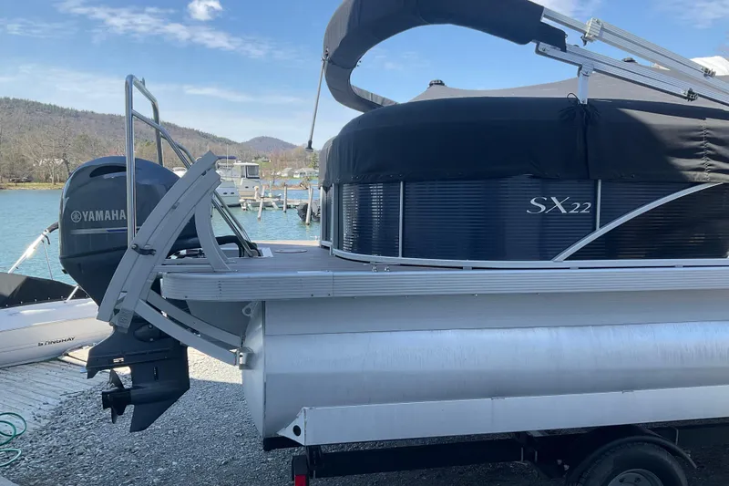 Slide: The Image of 2019 Bennington SX 20 SSRX pontoon boat with Yamaha motor, docked by a scenic lake. - 5