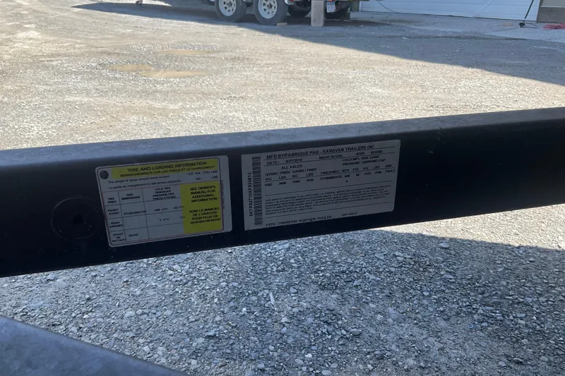 Slide: The Image of Trailer information labels on a 2019 Bennington SX 20 SSRX, parked on gravel. - 8