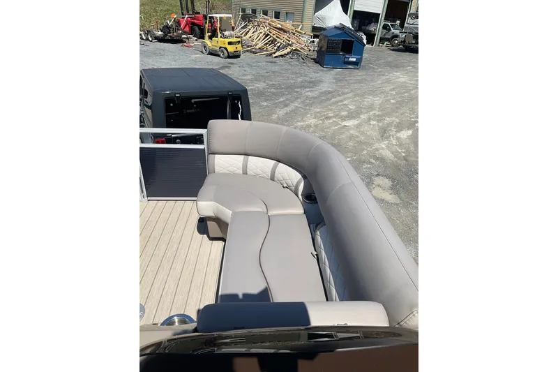Slide: The Image of 2019 Bennington SX 20 SSRX pontoon boat with beige seating and wooden deck. - 9