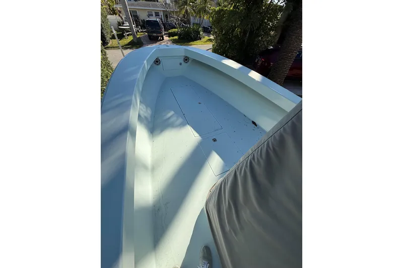Slide: The Image of 2007 Speed Sport 25 boat deck, light blue, parked outdoors. - 10