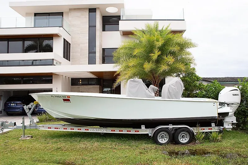 Slide: The Image of 2007 Speed Sport 25 boat on trailer, parked in front of modern house. - 3