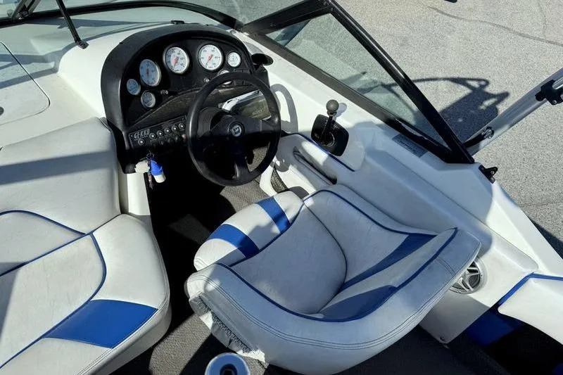Slide: The Image of Interior of a 2002 Gekko GTR-22 boat with steering wheel and gauges. - 13