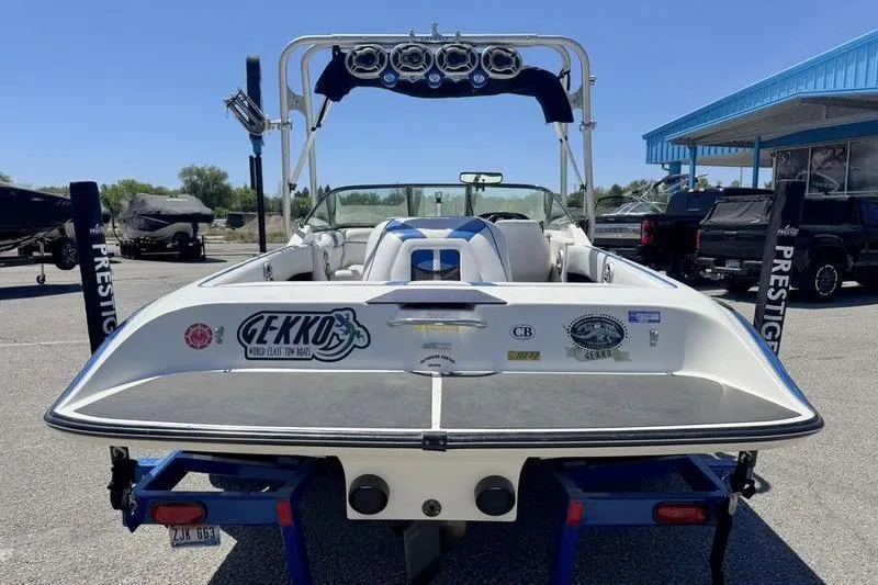 Slide: The Image of 2002 Gekko GTR-22 boat on trailer, rear view, with stickers and wakeboard tower. - 14