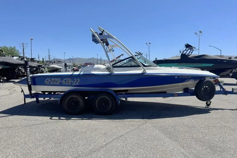 Slide: The Image of 2002 Gekko GTR-22 boat on trailer in sunny outdoor setting. - 4