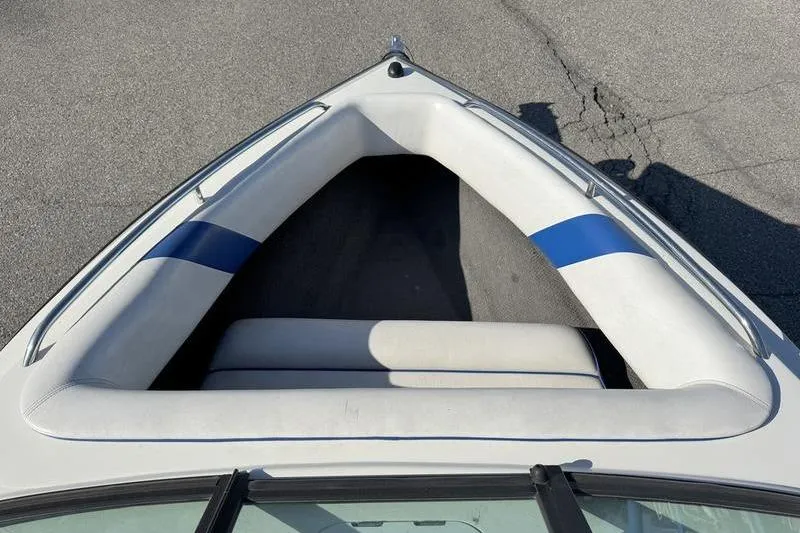 Slide: The Image of Bow seating area of 2002 Gekko GTR-22 boat with white and blue upholstery. - 6