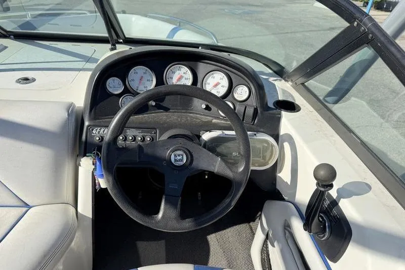 Slide: The Image of Cockpit view of a 2002 Gekko GTR-22 boat with steering wheel and gauges. - 7