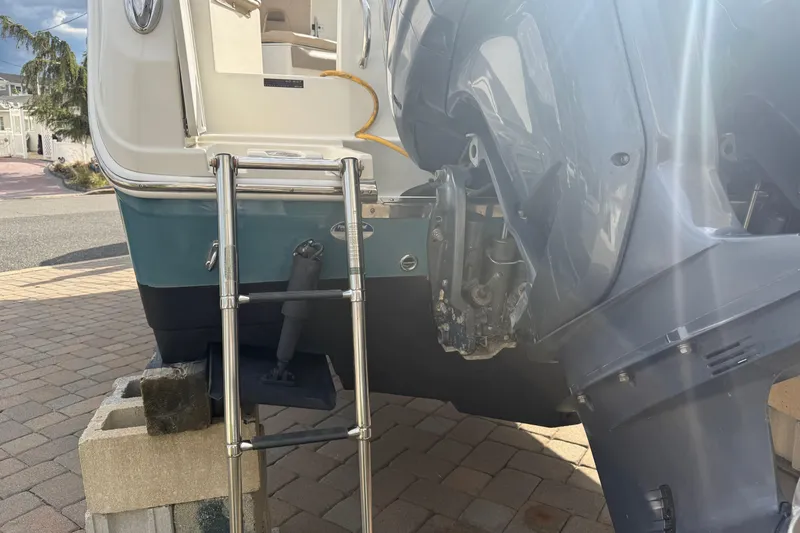 Slide: The Image of Rear view of a 2012 Sailfish 2680 WAC boat with ladder and outboard motor. - 12