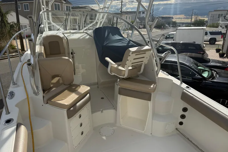 Slide: The Image of 2012 Sailfish 2680 WAC boat interior with seating and covered helm. - 13