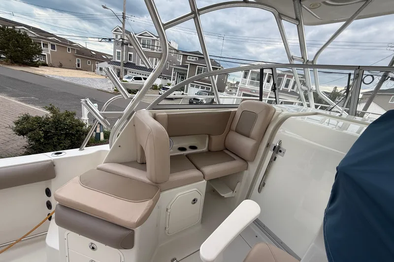 Slide: The Image of 2012 Sailfish 2680 WAC boat interior with beige seating and metal framework. - 19