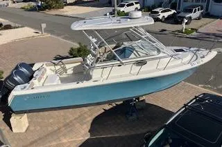 Slide: The Image of 2012 Sailfish 2680 WAC boat on display, featuring dual engines and a sleek design. - 2