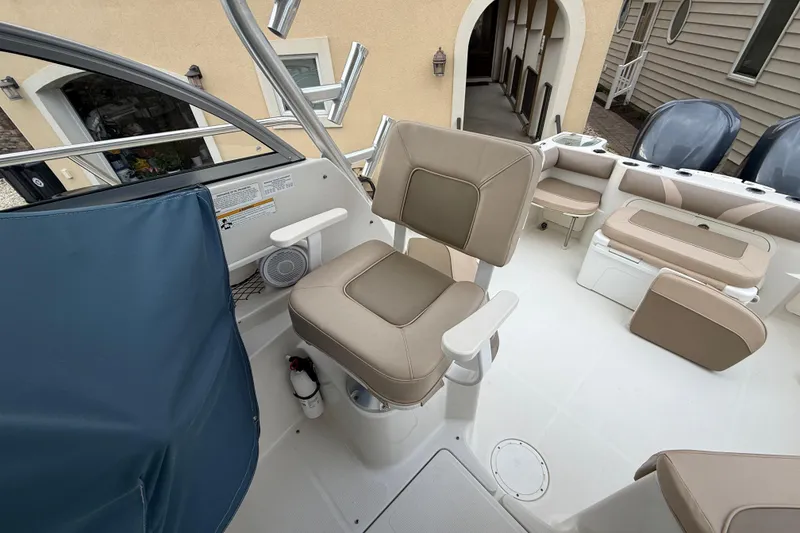 Slide: The Image of 2012 Sailfish 2680 WAC boat interior with beige seating and modern design. - 21