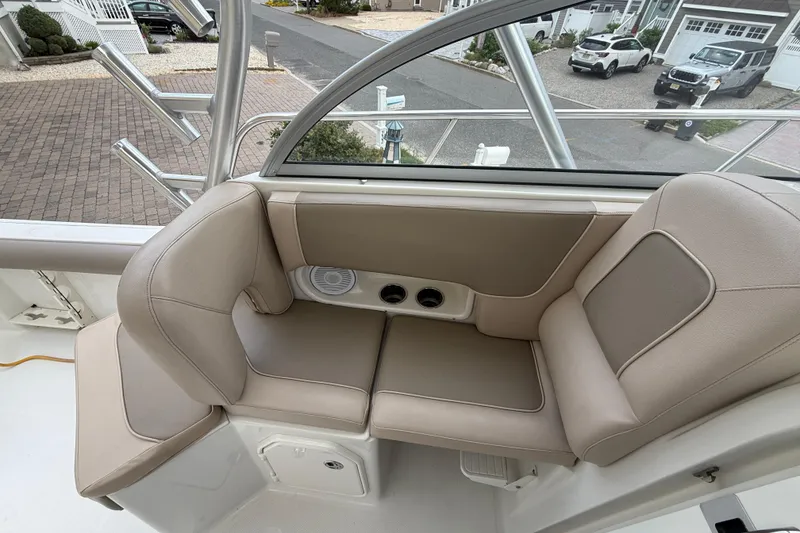 Slide: The Image of 2012 Sailfish 2680 WAC boat interior with beige seating and cup holders. - 22